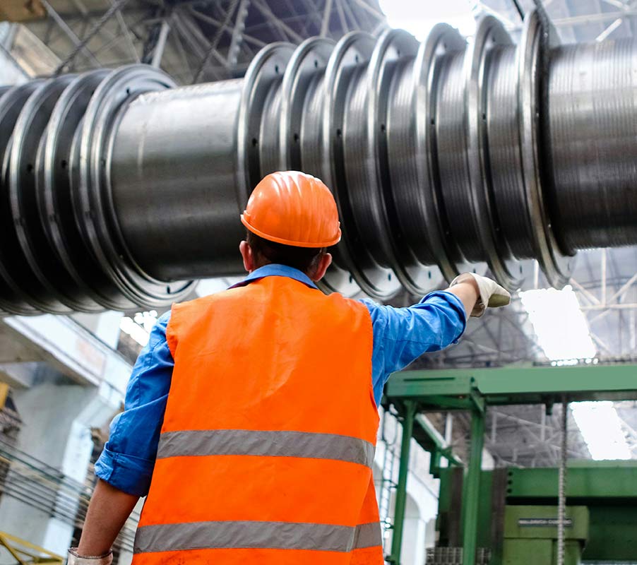 industrial worker inspecting heavy machinery